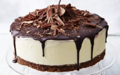 A frozen Black Forest Cheesecake garnished with drizzled chocolate and milk chocolate flakes