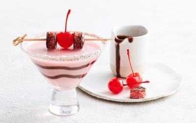 Creamy pink Cherry Ripe Martini adorned with Cherries and Cherry Ripe pieces