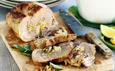 Sliced Pork Roast with Lemon and sage stuffing on a wooden chopping board