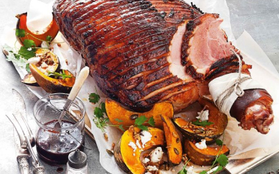 Glossy Spiced Cherry Bourbon Glazed Ham with roast pumpkin slices on a serving tray