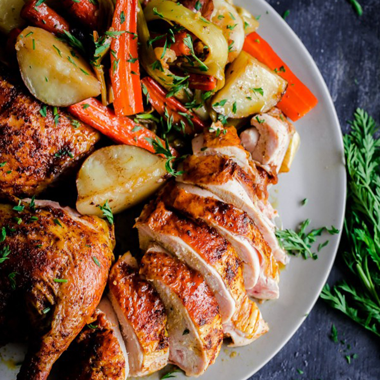 A white plate of Middle Eastern Roast Chicken and vegetables